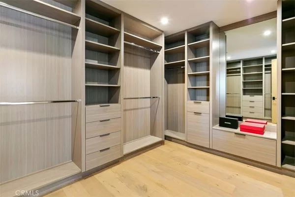 a view of walk in closet with empty racks