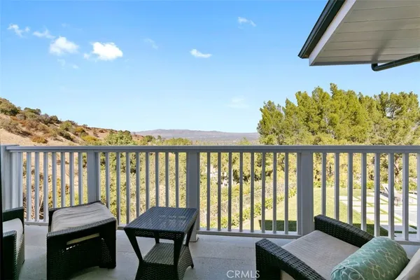 a view of a balcony with furniture