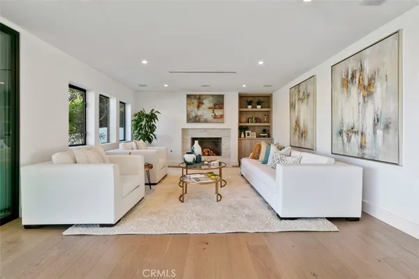 a living room with fireplace furniture and a large window