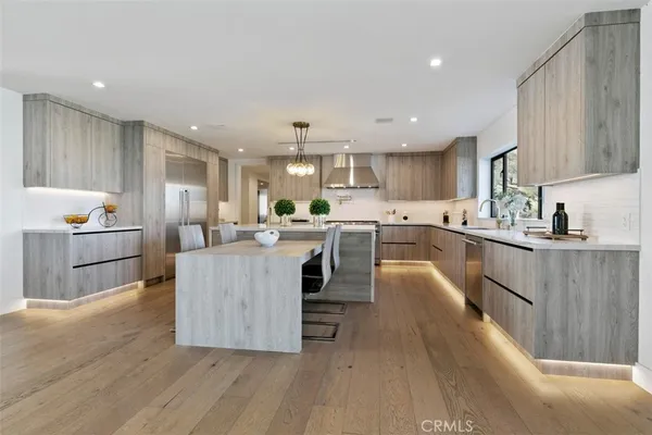 a kitchen with counter top space a sink cabinets and appliances
