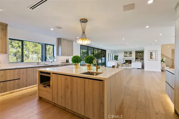 a kitchen with kitchen island a large counter top space appliances and windows