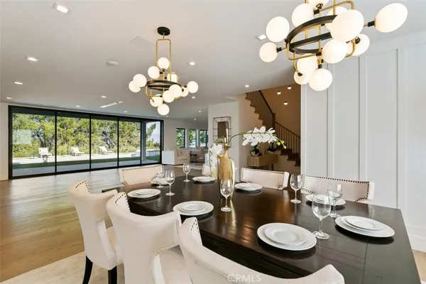 a view of a dining room with furniture wooden floor and chandelier