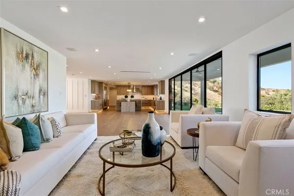 a living room with furniture and floor to ceiling window