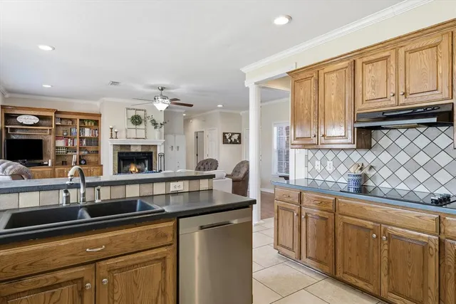 a kitchen with stainless steel appliances granite countertop a sink and cabinets