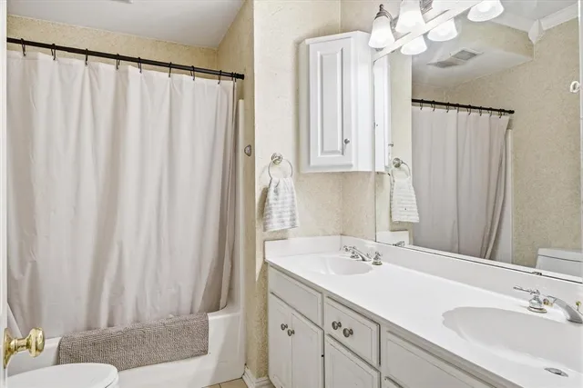 a bathroom with a double vanity sink mirror and double