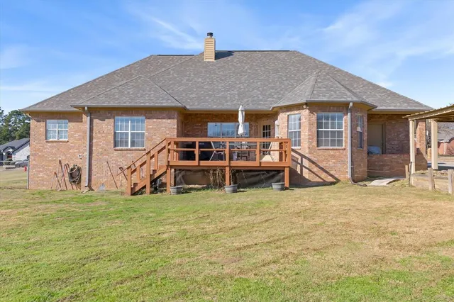a view of a house with backyard porch and sitting area