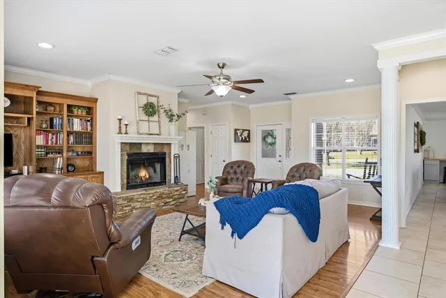 a living room with furniture a fireplace and a chandelier