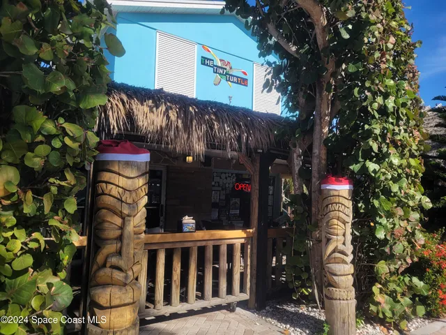 a view of a house with a yard and a garage