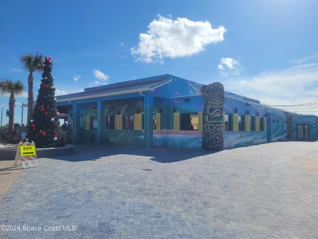 a view of a house with a yard and a garage