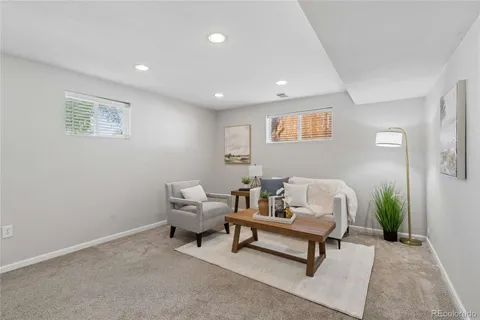 a living room with furniture and a potted plant