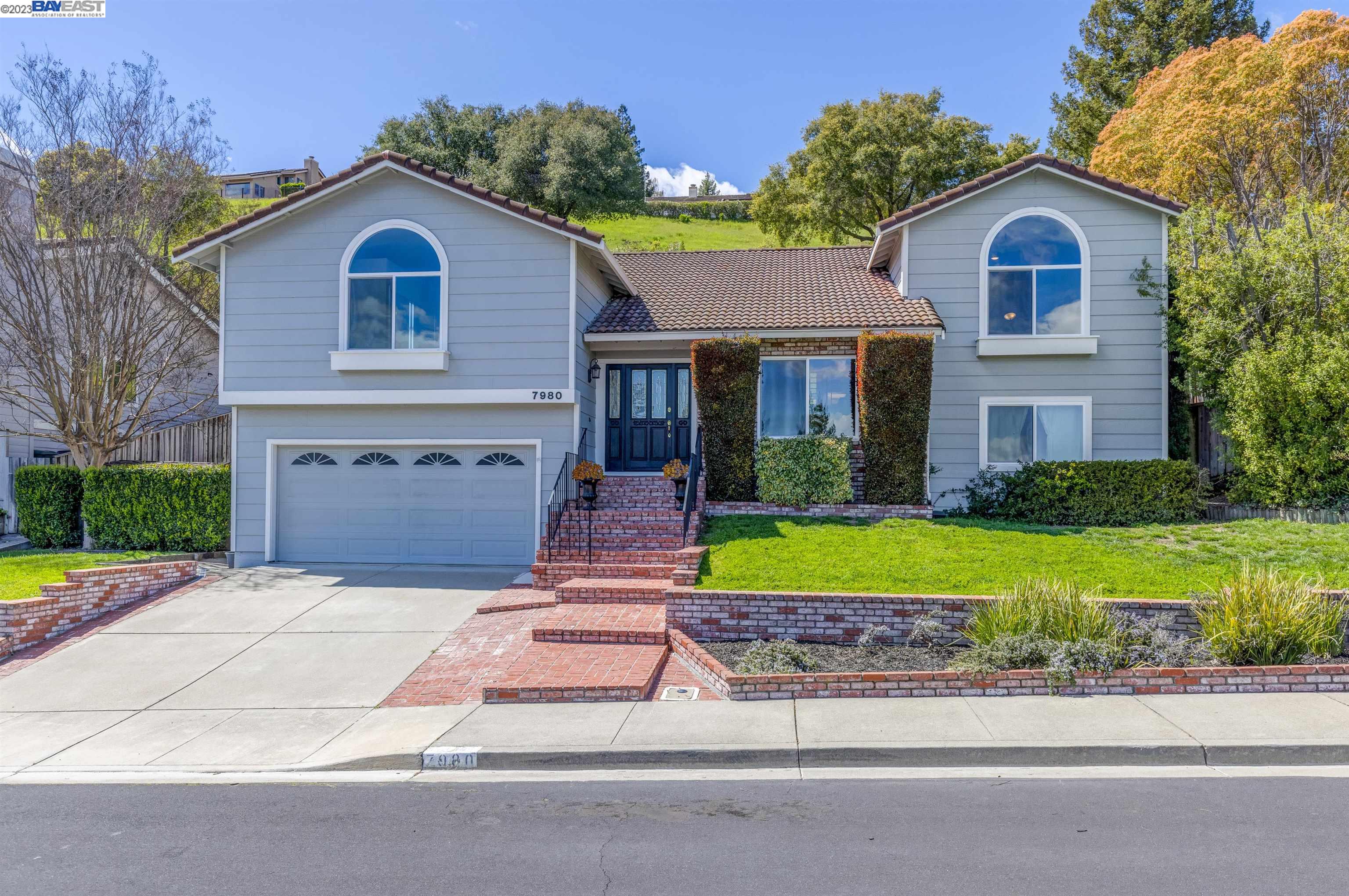 a front view of a house with a yard and garage