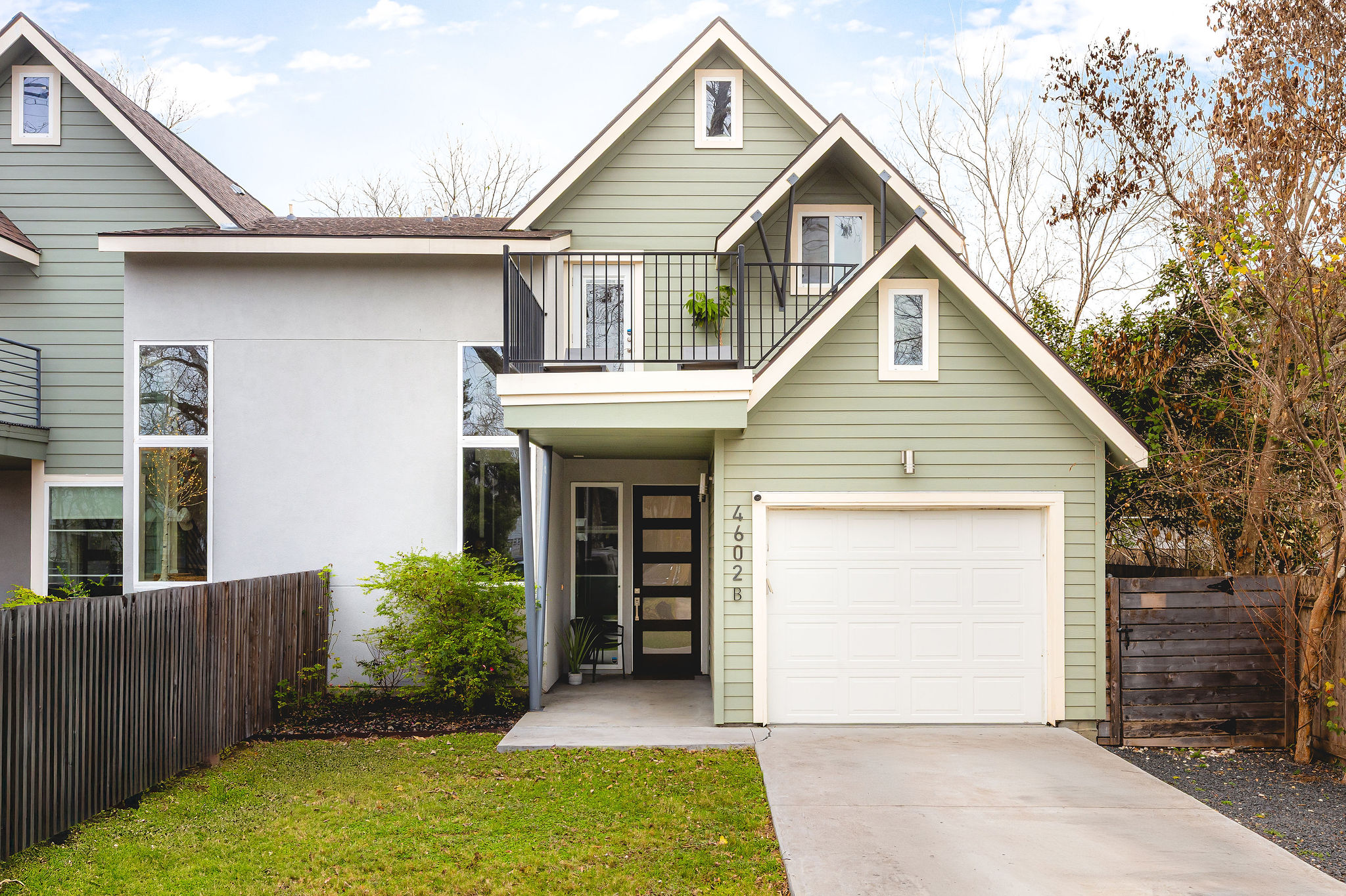 a front view of a house with a garden and plants