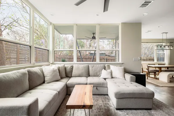 a living room with furniture and large windows