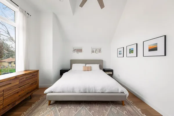 a bedroom with a bed and a window