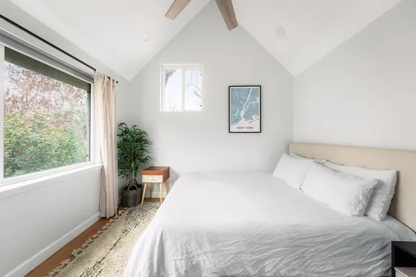 a bedroom with a large bed and a window