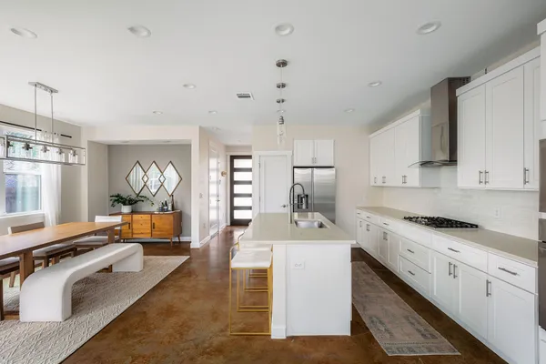 a kitchen with stainless steel appliances granite countertop a sink stove and refrigerator