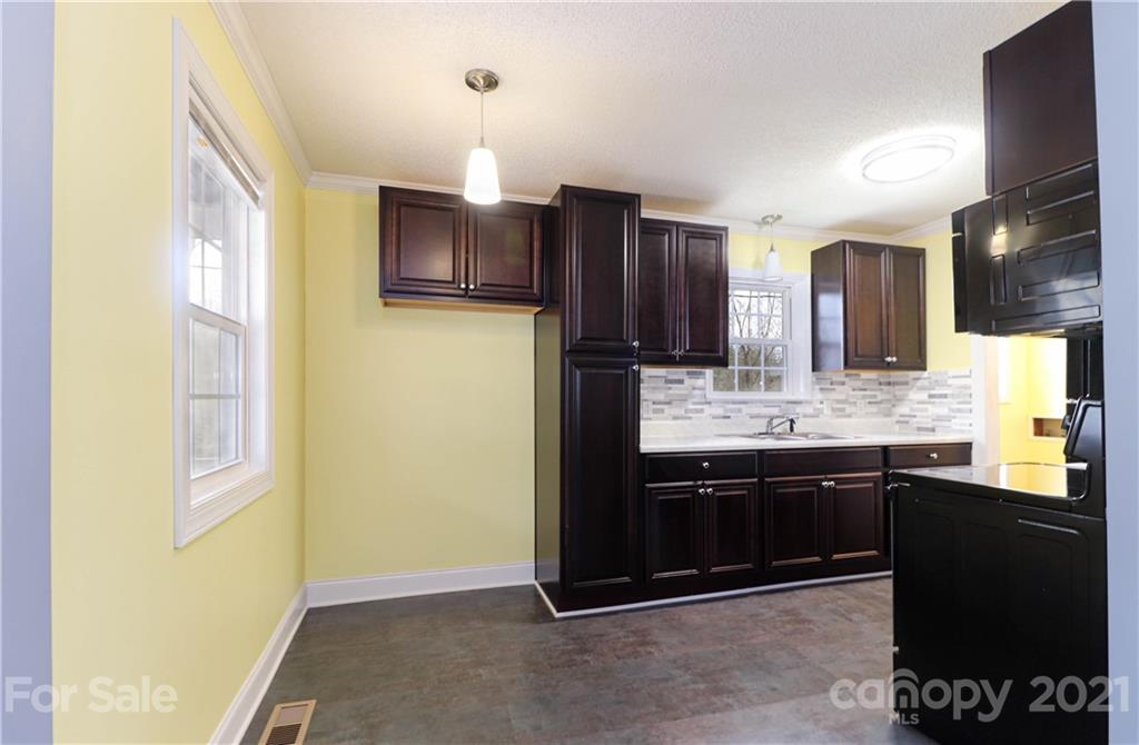 1731 Tradesville Road, Unit 5 Lancaster, SC 29720 - Photo 8 of 25 a kitchen with stainless steel appliances granite countertop a sink and a refrigerator