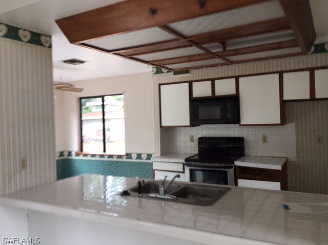 18312 Lee Road Fort Myers, FL 33967 - Photo 8 of 16 a living room with furniture and a fireplace