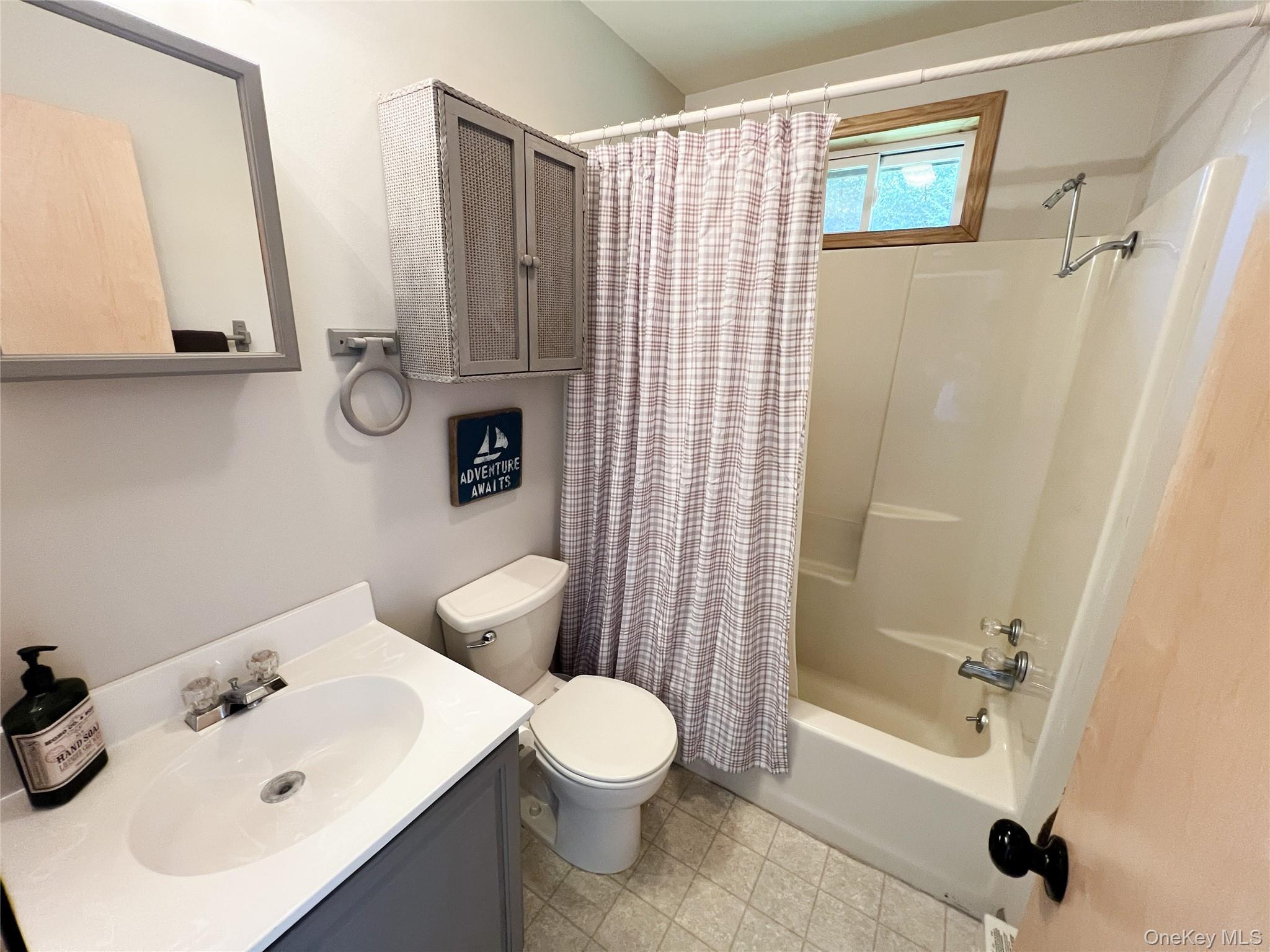 295 Emerald Heights Road Delancey, NY 13752 - Photo 22 of 30 Bathroom featuring a single vanity with a white countertop and integrated sink, a built-in shower-tub combination, and tiled flooring