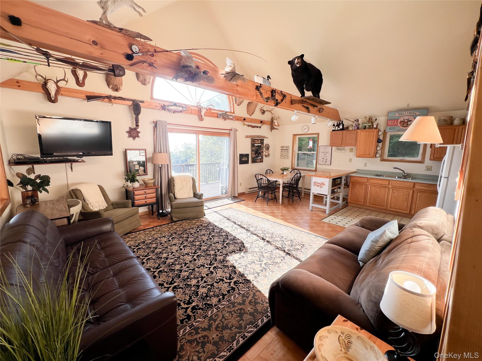 295 Emerald Heights Road Delancey, NY 13752 - Photo 23 of 30 Open-concept living area featuring vaulted ceilings with exposed wood beams