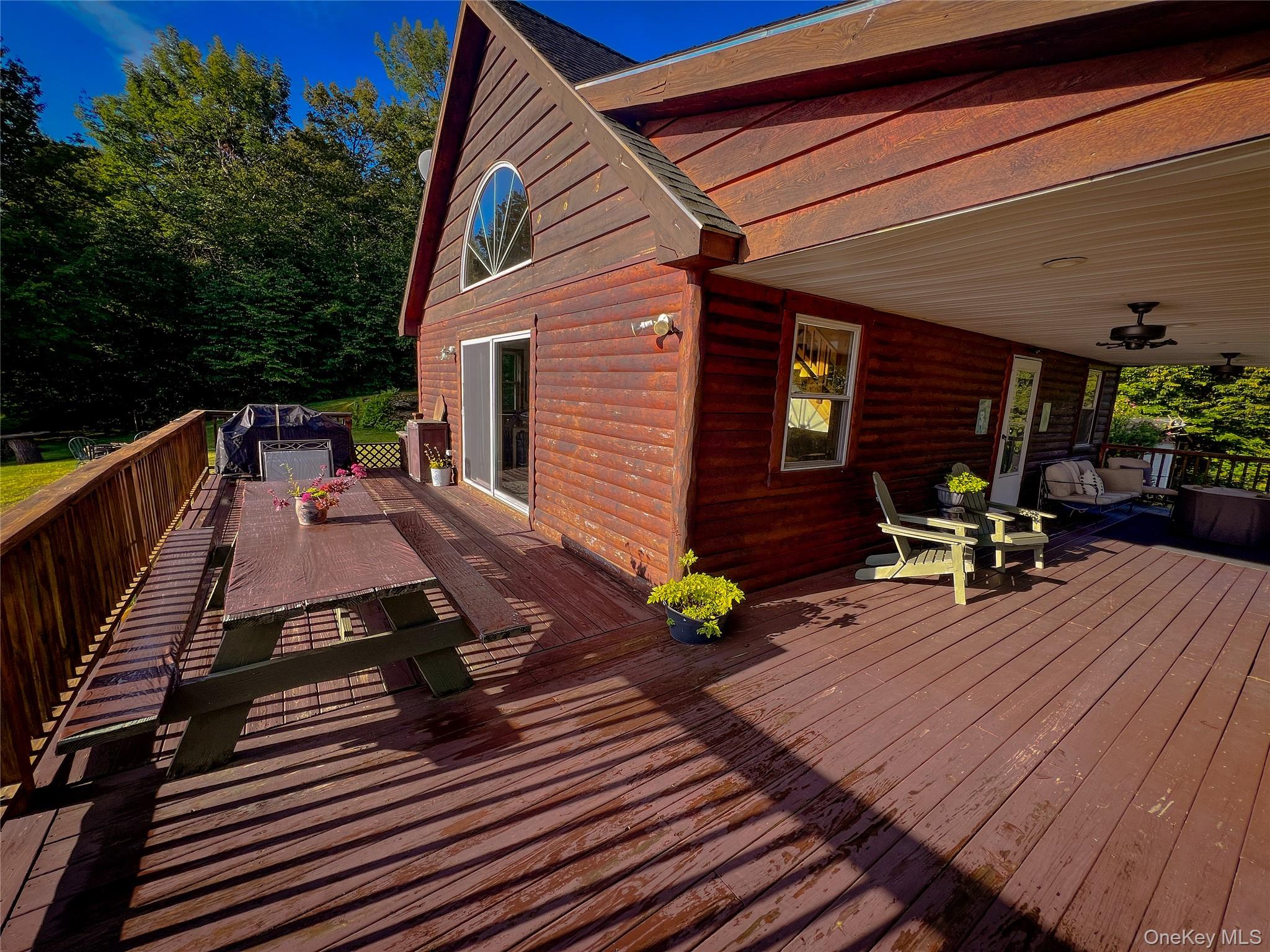 295 Emerald Heights Road Delancey, NY 13752 - Photo 24 of 30 Expansive wood-finish deck with a rustic railing and a covered porch area