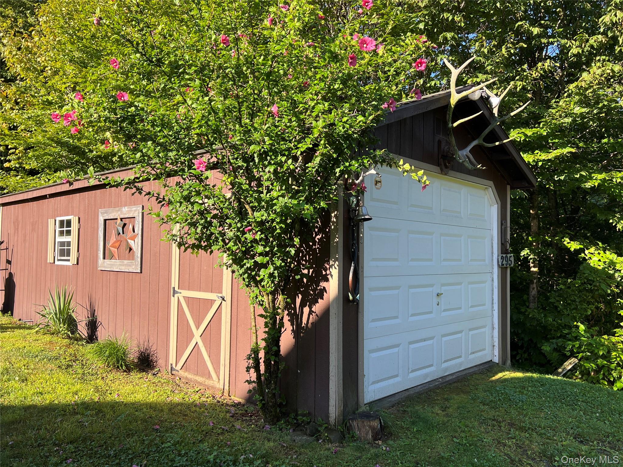 295 Emerald Heights Road Delancey, NY 13752 - Photo 5 of 30 Freestanding garage structure featuring a panel-style door and dark brown siding
