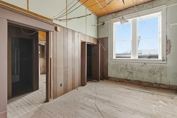 a bedroom with furniture and a window