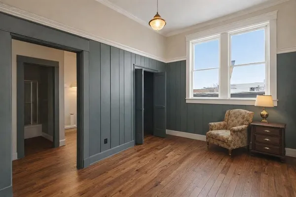 a living room with kitchen island furniture a chandelier a sink and a window