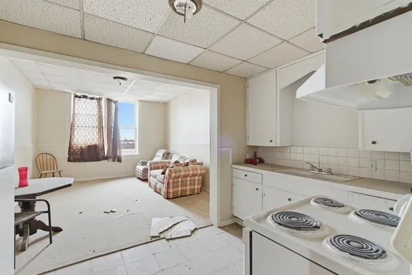 a kitchen with granite countertop cabinets and white appliances