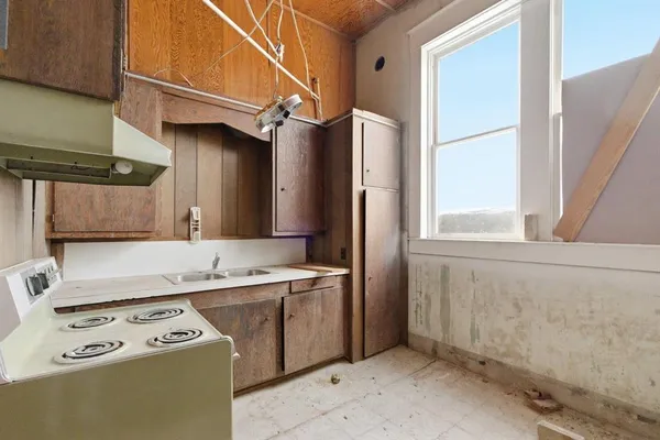 a bedroom with a bed a couch and large window