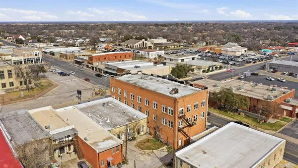 an aerial view of a building with an outdoor space