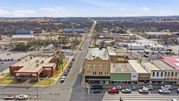 an aerial view of a building with parking