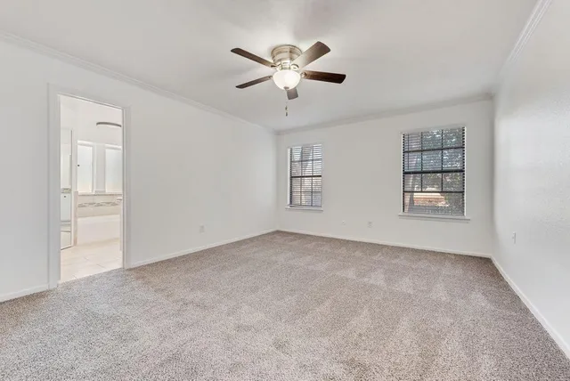 a view of an empty room with a ceiling fan