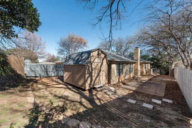 a view of a backyard with a tree