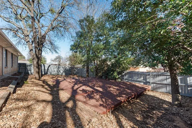 a view of a yard with trees