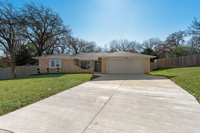 a front view of house with yard and trees