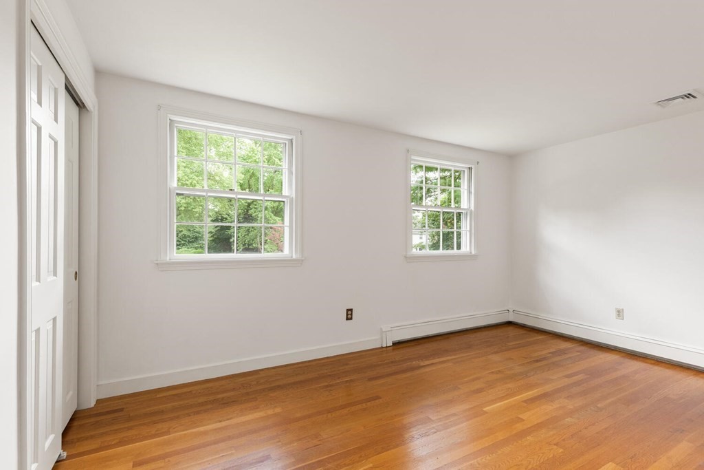 29 Saddle Club Road Lexington, MA 02420 - Photo 13 of 22 an empty room with wooden floor and windows
