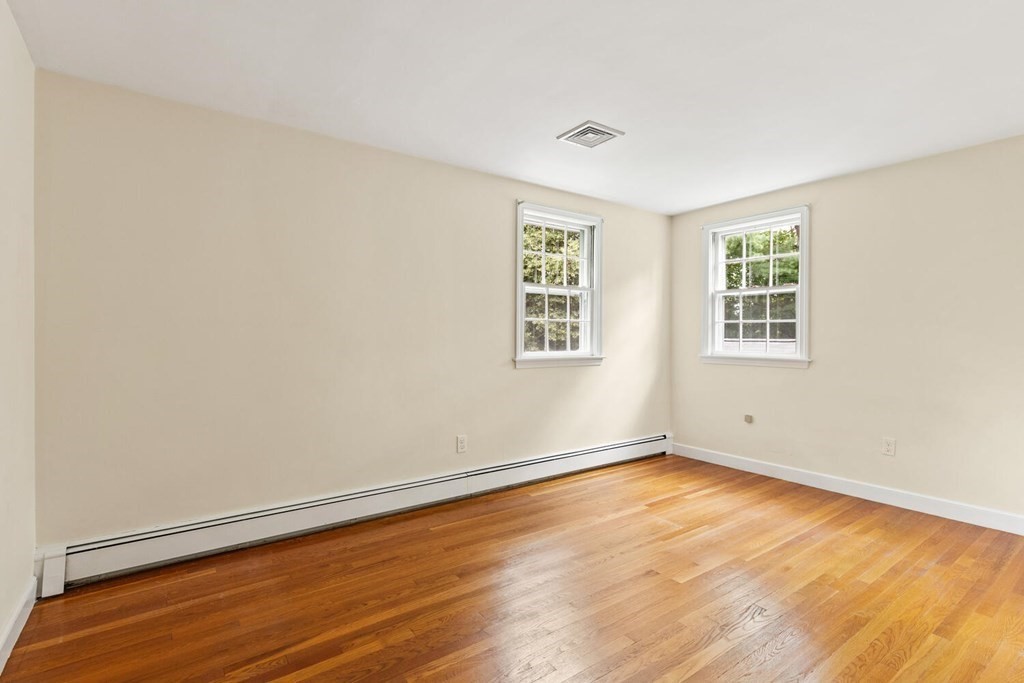 29 Saddle Club Road Lexington, MA 02420 - Photo 14 of 22 an empty room with wooden floor and windows