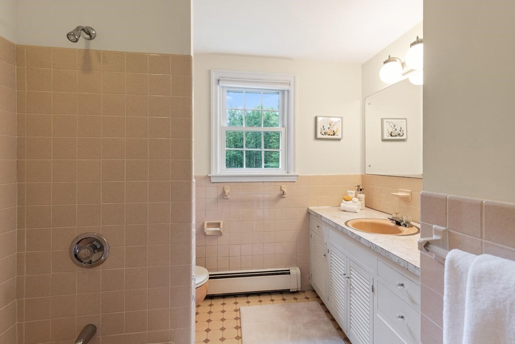 29 Saddle Club Road Lexington, MA 02420 - Photo 15 of 22 a bathroom with a sink a toilet and shower