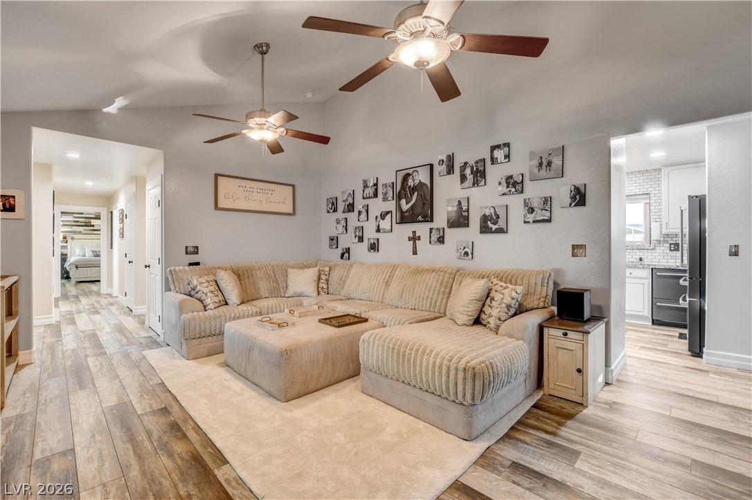 6460 Racel Street Las Vegas, NV 89131 - Photo 34 of 59 An open layout connects the living room to adjacent areas over handsome plank flooring.