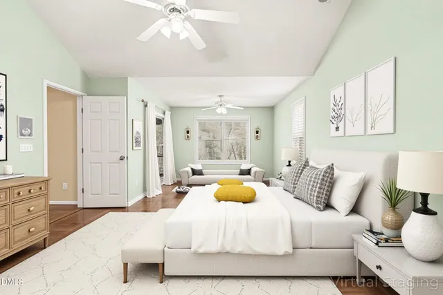 a bedroom with a large bed and a chandelier