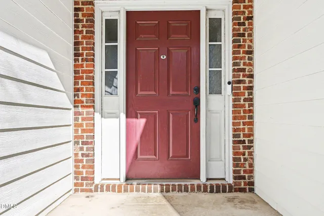 a view of a door of a house with a door and wooden floor