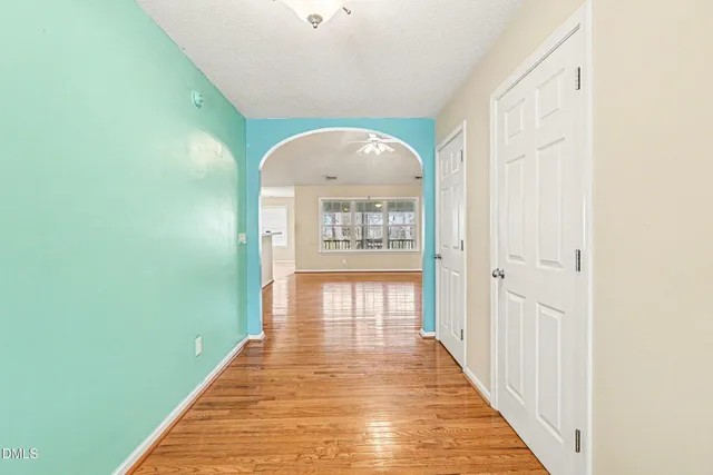 a view of a hallway with wooden floor