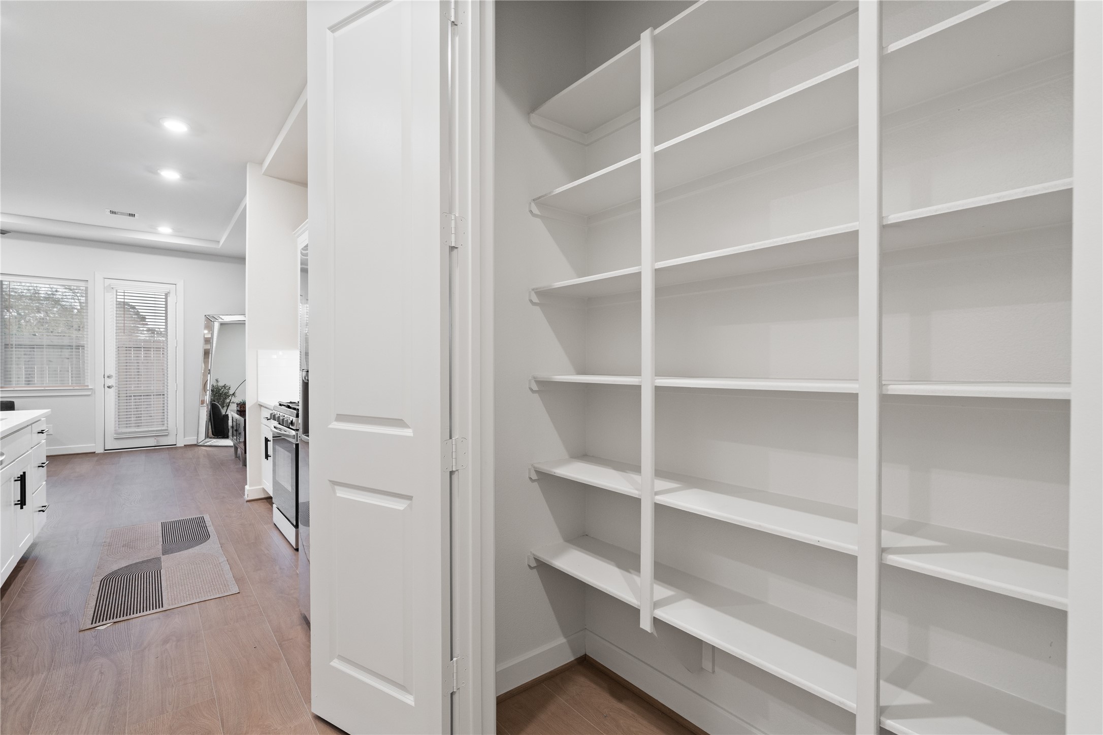 6451 Rena Street Houston, TX 77092 - Photo 17 of 33 Reach in pantry with built in full height shelving, keeping dry goods and kitchen storage organized and out of sight.