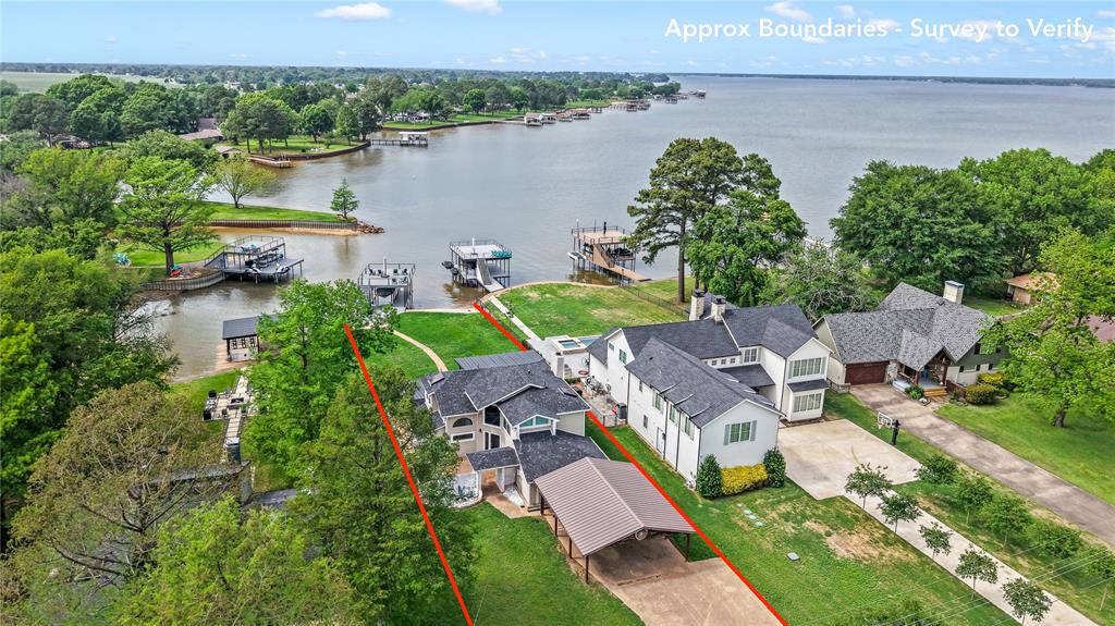 125 Xit Ranch Road Trinidad, TX 75163 - Photo 1 of 34 an aerial view of a house with outdoor space and lake view