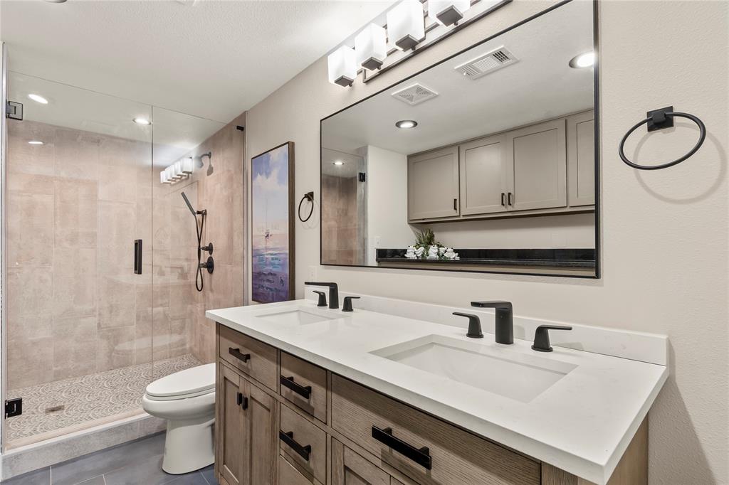 125 Xit Ranch Road Trinidad, TX 75163 - Photo 13 of 34 a bathroom with a double vanity sink mirror and toilet