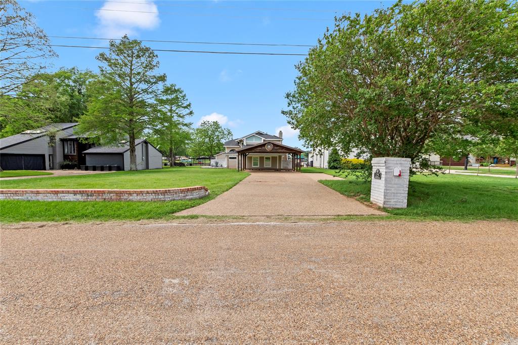 125 Xit Ranch Road Trinidad, TX 75163 - Photo 34 of 34 a white house with a big yard and large trees