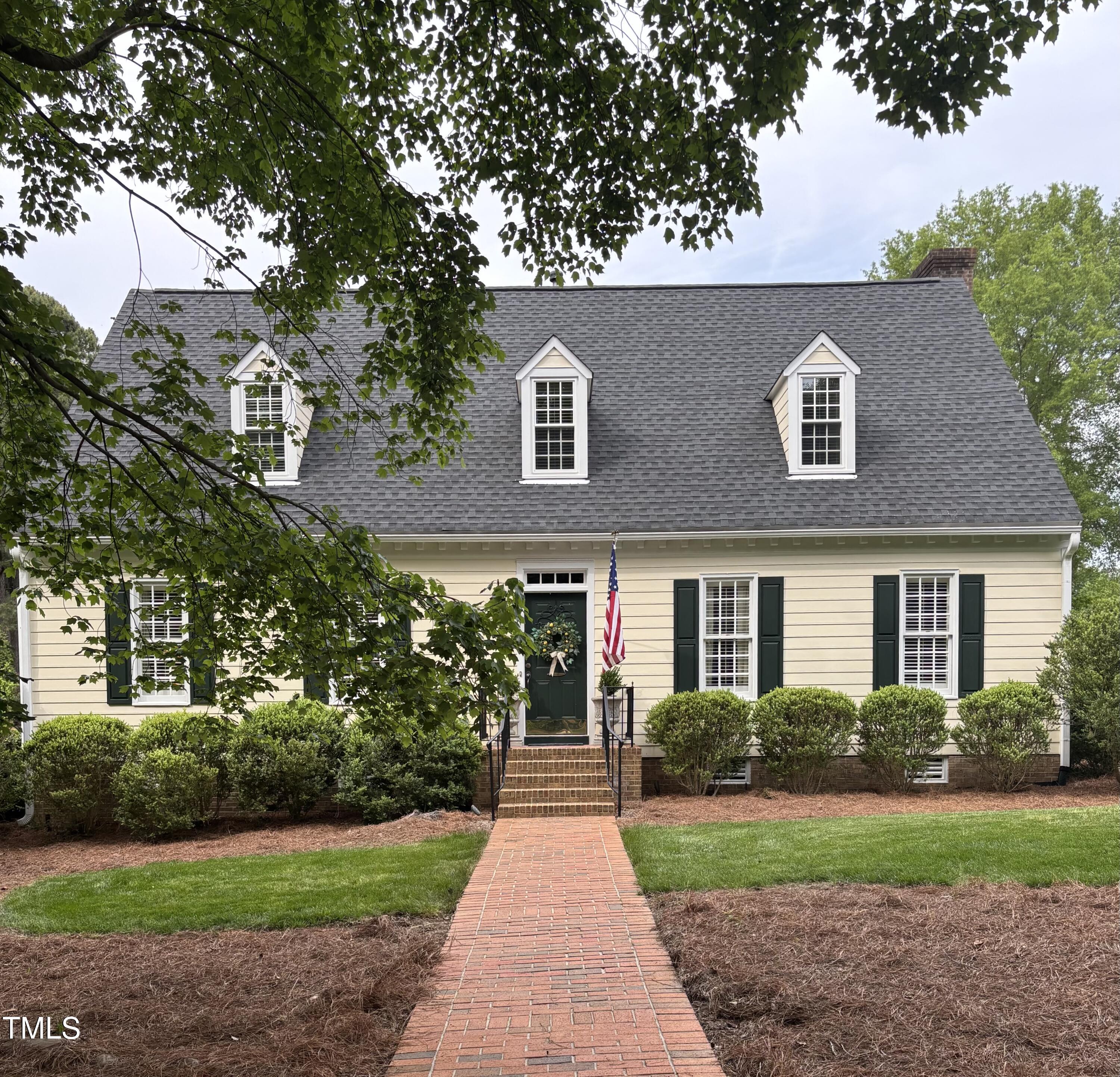 9301 Brookton Court Raleigh, NC 27615 - Photo 1 of 29 a front view of a house with a yard