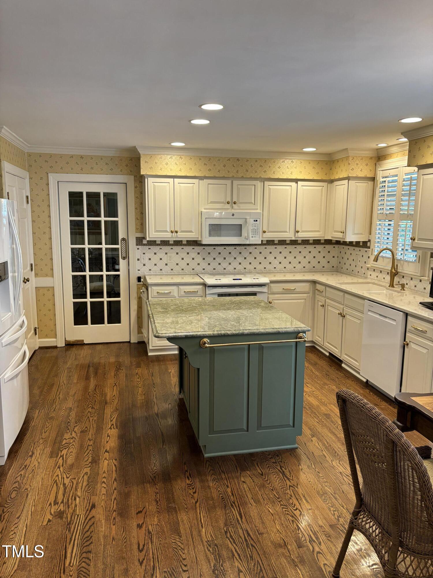 9301 Brookton Court Raleigh, NC 27615 - Photo 13 of 29 a kitchen with a stove a sink and a refrigerator