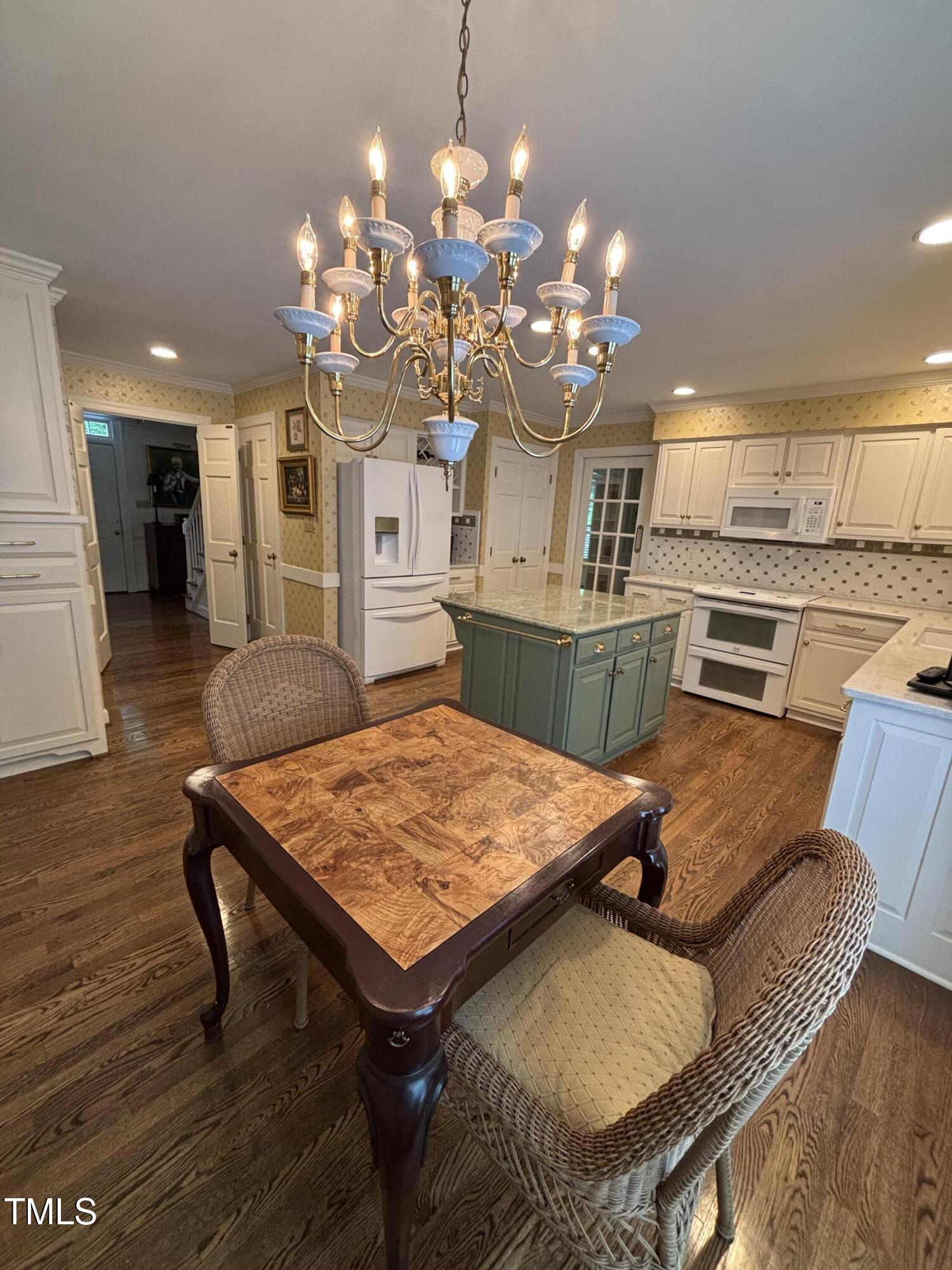 9301 Brookton Court Raleigh, NC 27615 - Photo 15 of 29 a kitchen with a table and chairs in it